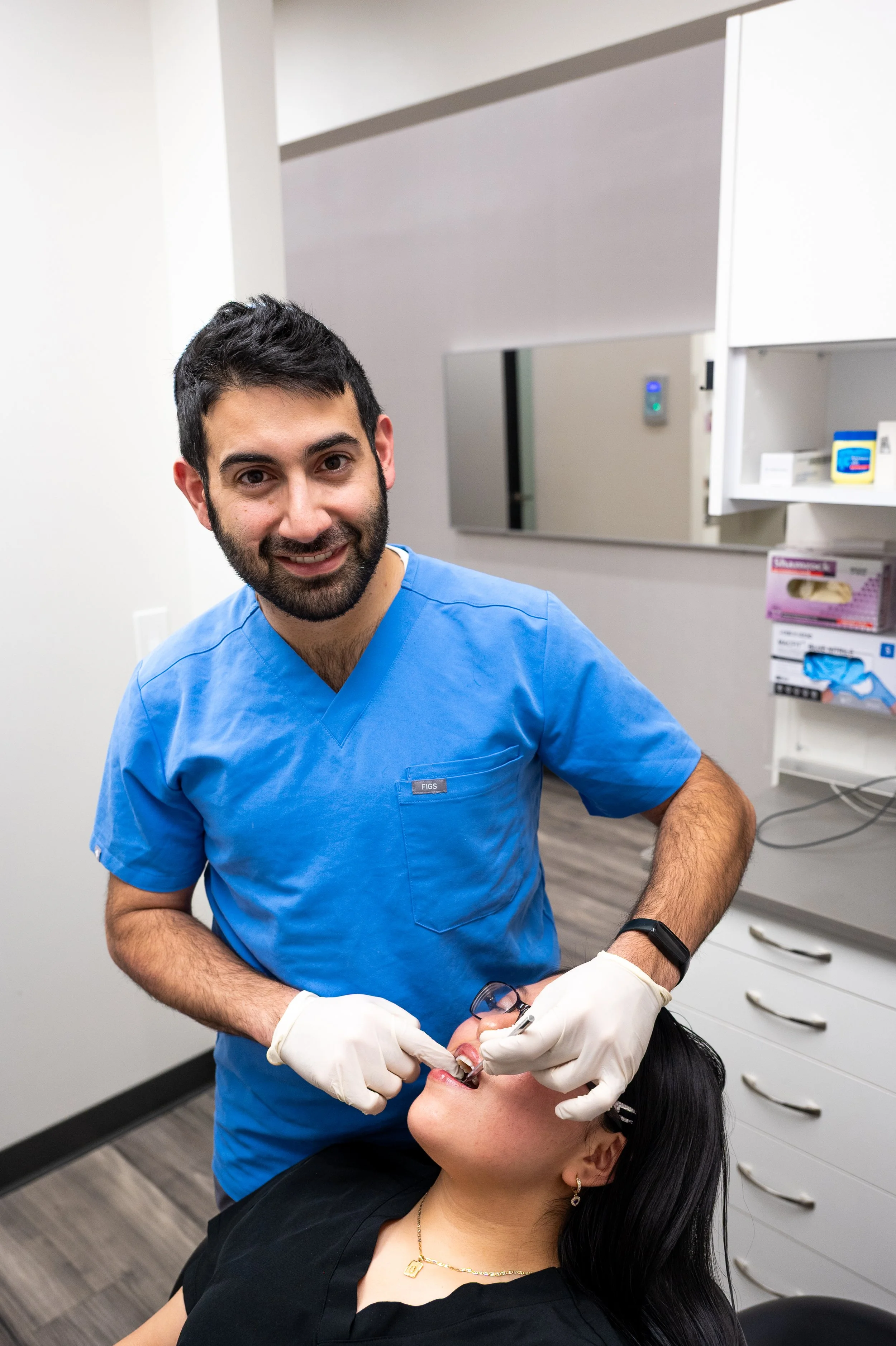 Dr. Joshua Ishal treating a patient at Luna Dental in Astoria, NY